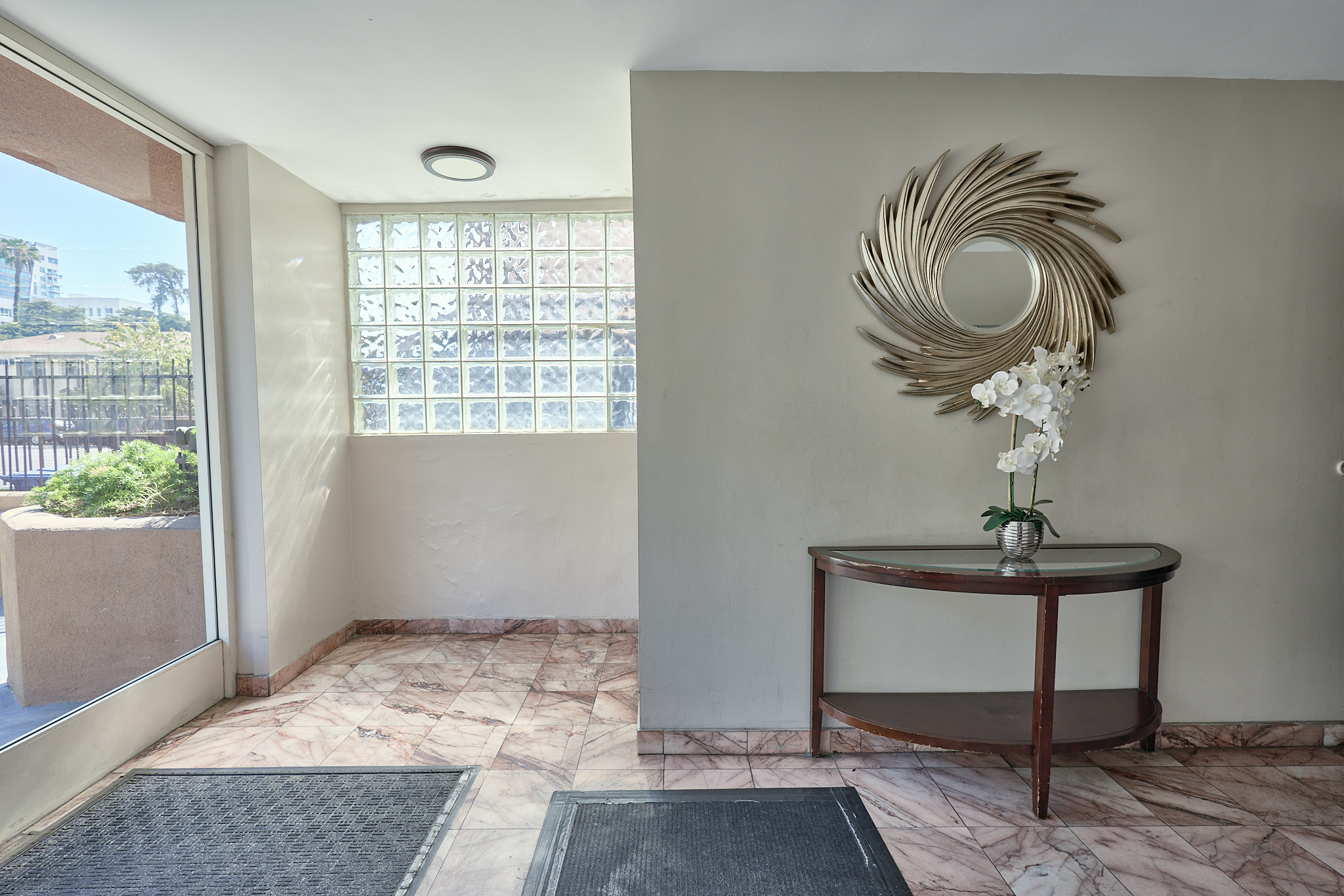 A room with a round table and a wall art.